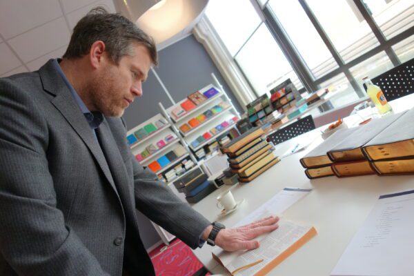 Sky Cline examining a Bible in production